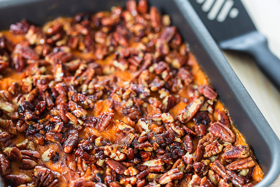 Sweet potato casserole with pecans in a baking dish