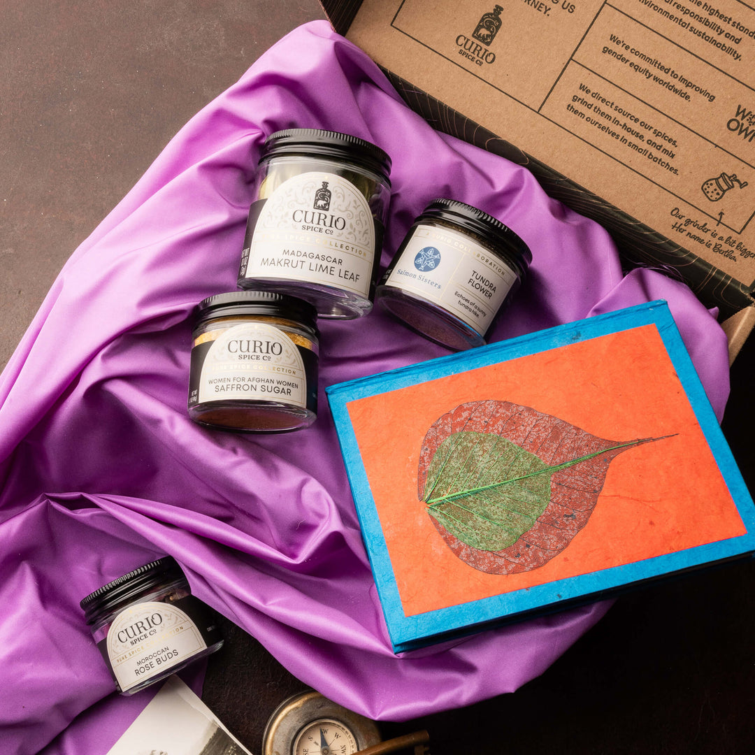 Curio products on a purple fabric with a decorative notebook