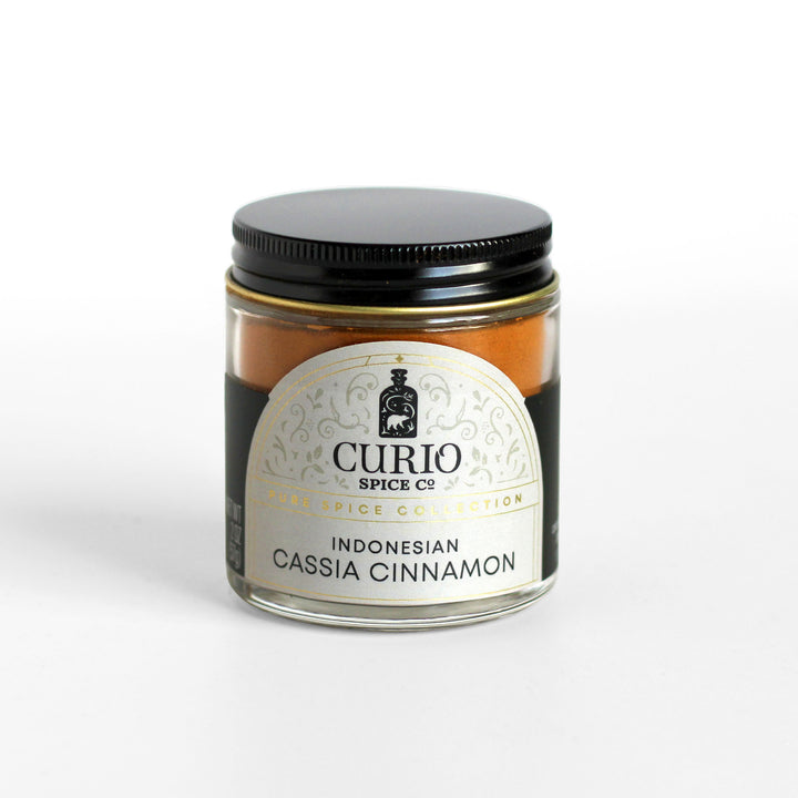 Ground Indonesian cassia cinnamon in a Curio Spice glass jar