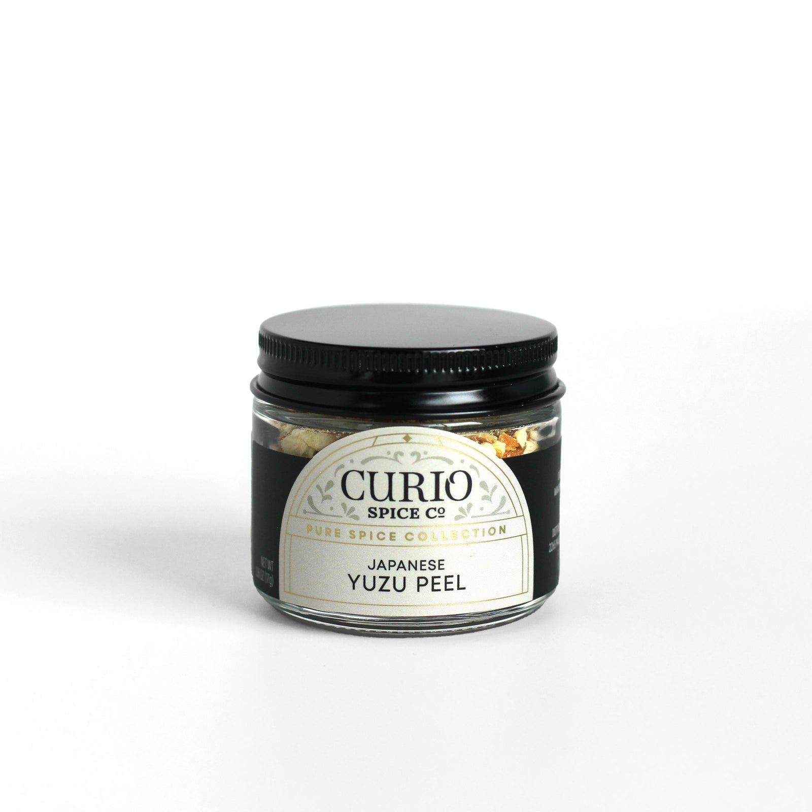Glass jar filled with Japanese Yuzu Peel showing the Curio Spice logo.