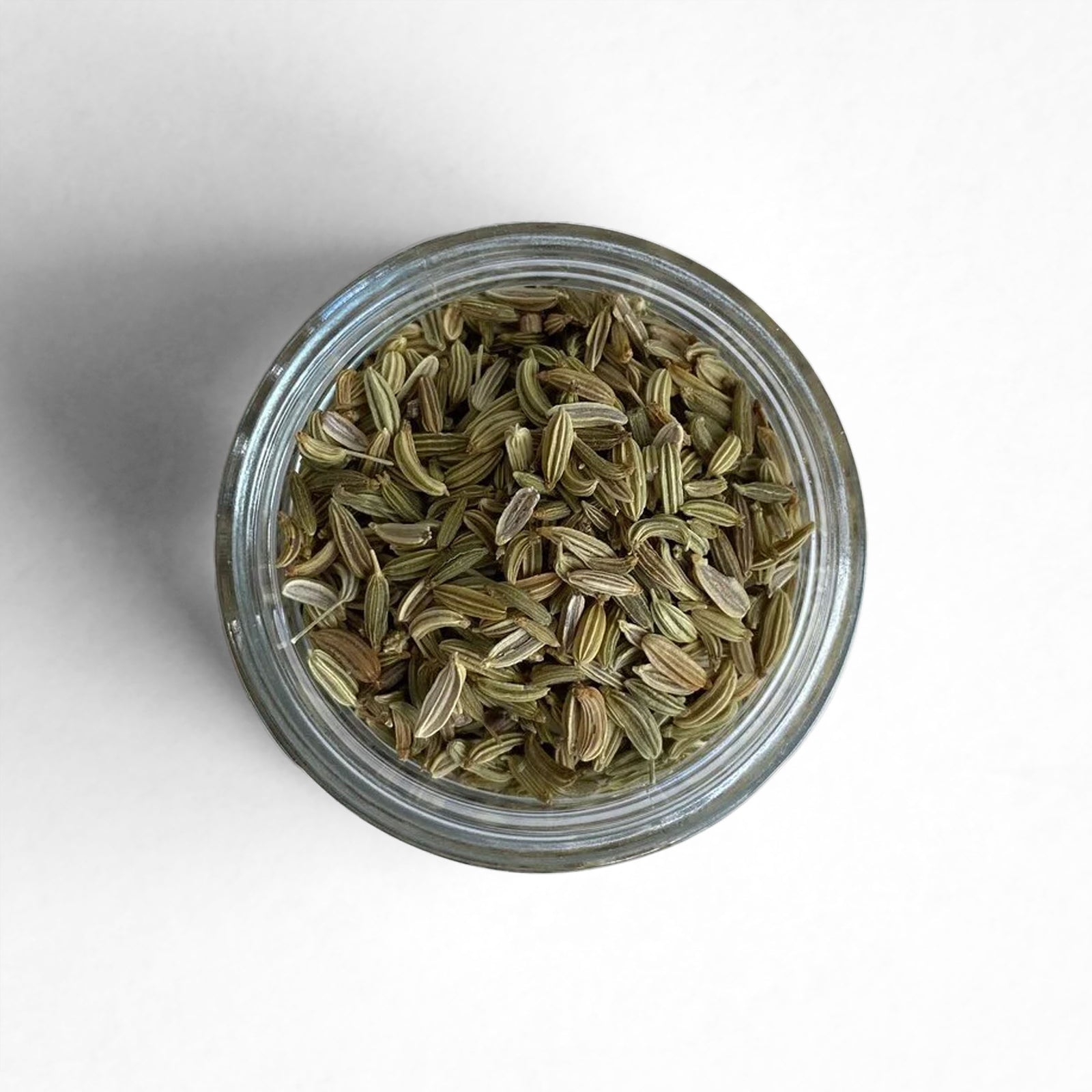 Curio Spice Co. fair-trade single origin sustainable fennel seed in a glass jar from above.