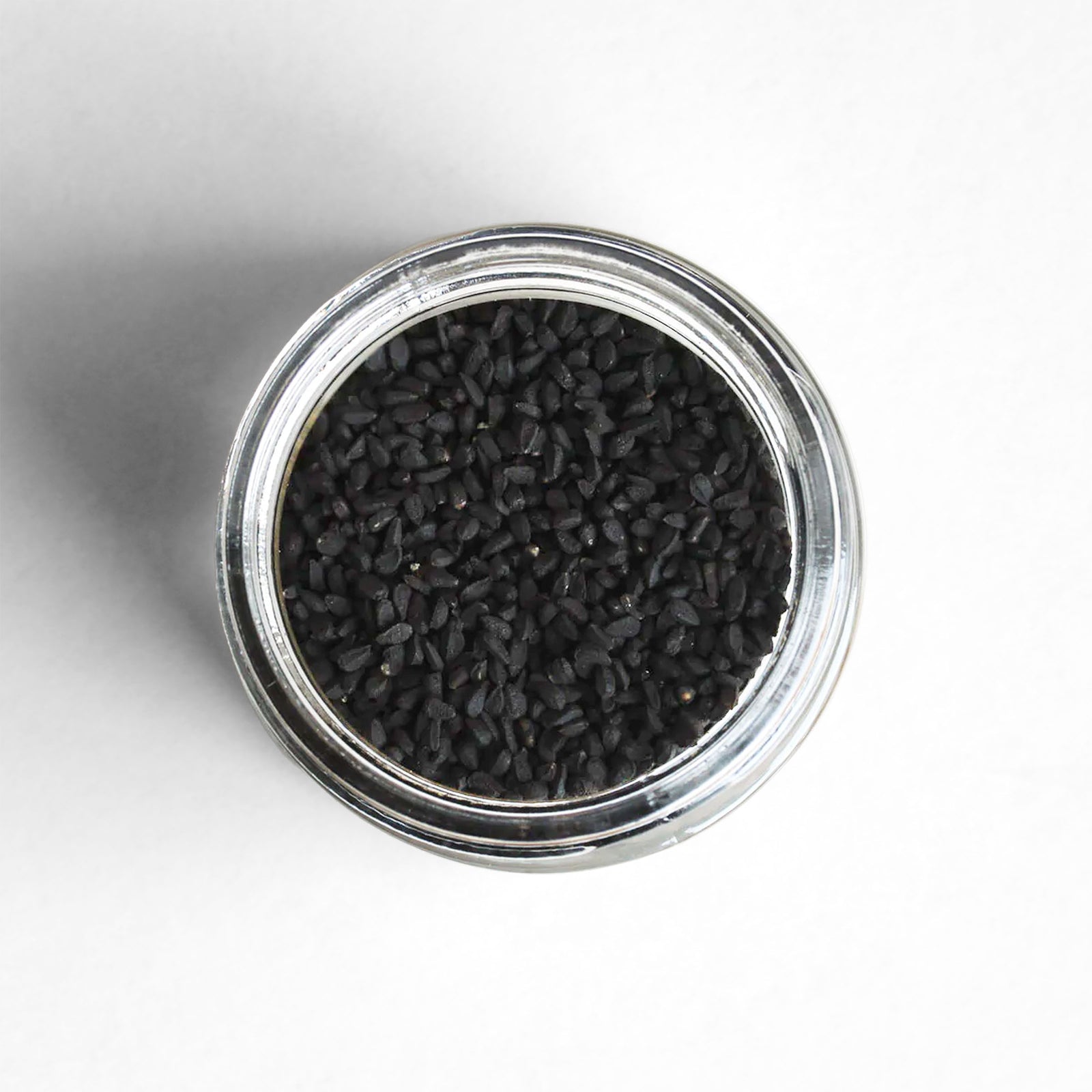 Curio Spice Co. fair-trade single origin sustainable nigella seed in a glass jar from above.