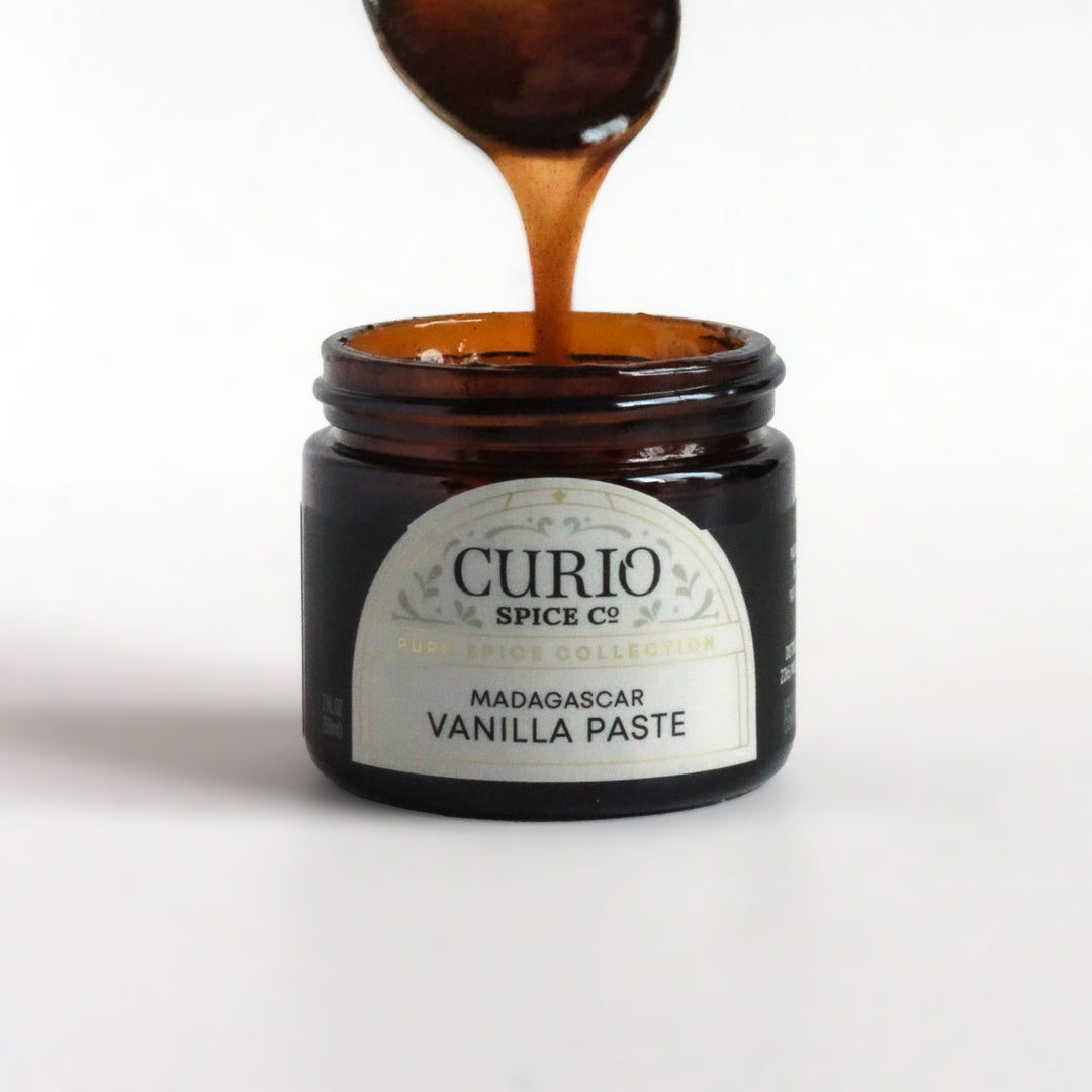 A spoon dipping into a jar of Curio Spice&
